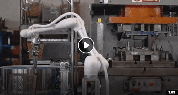 A robot is moving along the floor of an industrial setting.