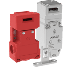A red and white electrical device on green background.