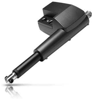 A black electric motor is sitting on the ground.