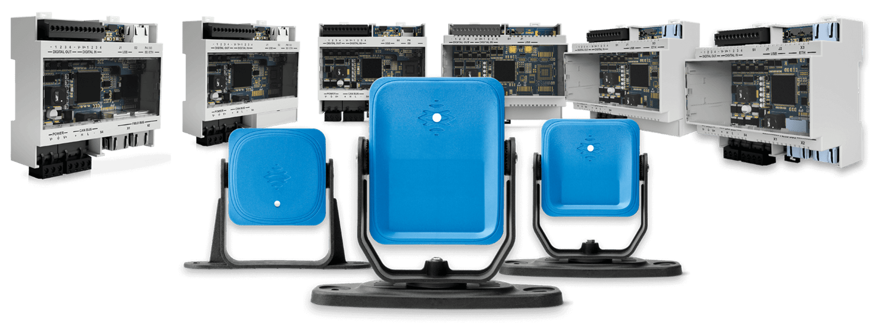 Three blue outdoor speakers with industrial equipment in the background.