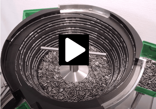 Seeds being roasted in a rotating drum machine.