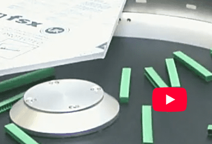 Metal disk and green rectangular bars on table