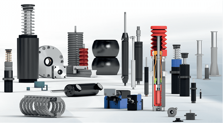 Various industrial shock absorbers and dampers displayed on a white surface.