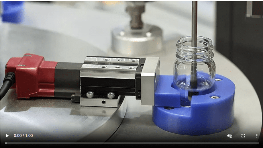 Automated lab equipment dispensing liquid into a vial.