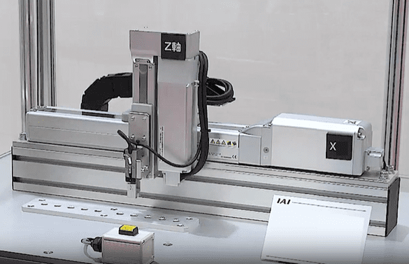 A robotic arm operates over a conveyor belt for automated tasks.